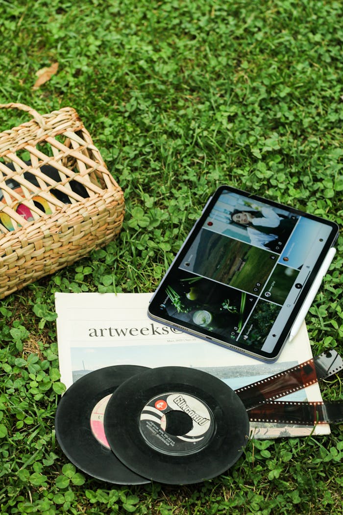 services-02 Vintage vinyl records and a modern tablet on grass create a nostalgic juxtaposition.